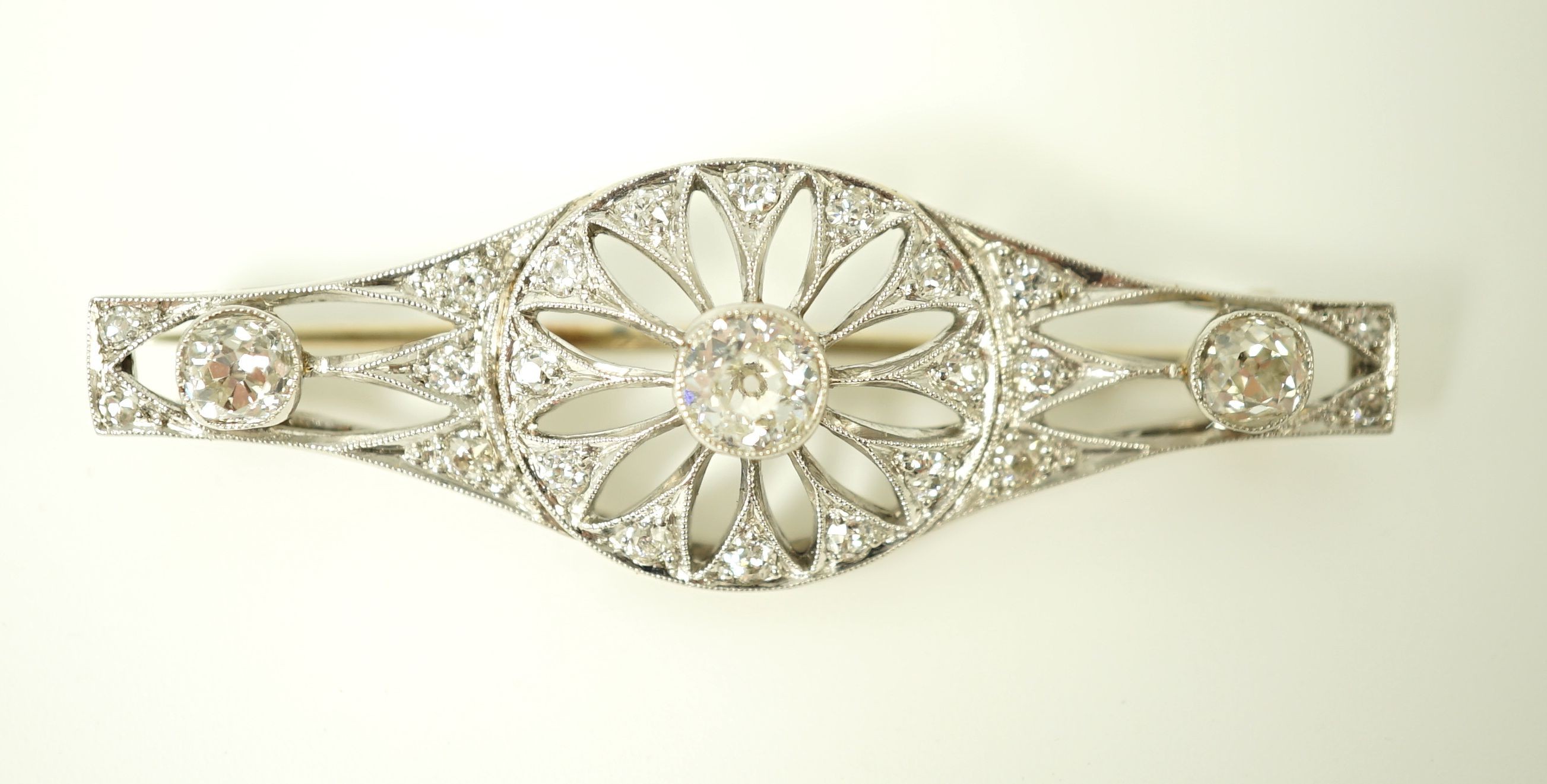 A 1920's pierced white gold and diamond cluster set brooch